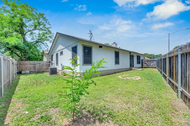 5901 Jacob Gln, Austin, TX 78727 - back of house with central air condition unit, stucco siding, and a chimney