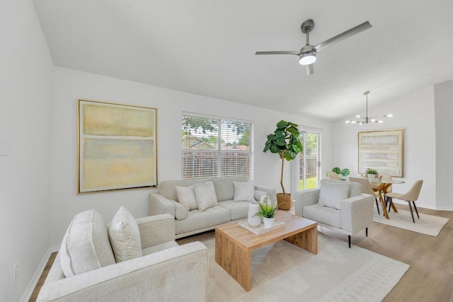 5901 Jacob Gln, Austin, TX 78727 - living area with vaulted ceiling, a chandelier, wood finished floors, baseboards, and ceiling fan