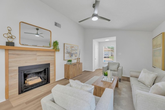 5901 Jacob Gln, Austin, TX 78727 - living room featuring a ceiling fan, vaulted ceiling, wood finished floors, and a fireplace