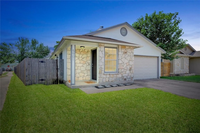 5901 Jacob Gln, Austin, TX 78727 - view of front of house featuring stone siding, driveway, and an attached garage