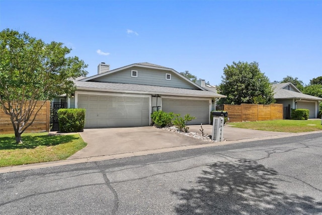 3317 William Cannon Dr Unit A, Austin, TX 78745 - view of front facade with a chimney, driveway, and an attached garage