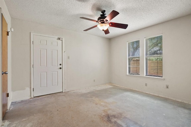 3317 William Cannon Dr Unit A, Austin, TX 78745 - spare room featuring unfinished concrete flooring, a textured ceiling, and a ceiling fan