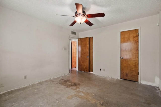 unfurnished bedroom featuring unfinished concrete floors, a textured ceiling, and ceiling fan