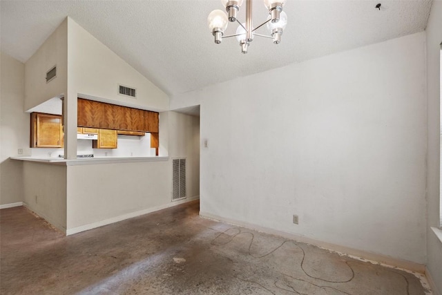 3317 William Cannon Dr Unit A, Austin, TX 78745 - unfurnished living room featuring a chandelier, concrete flooring, baseboards, a textured ceiling, and high vaulted ceiling