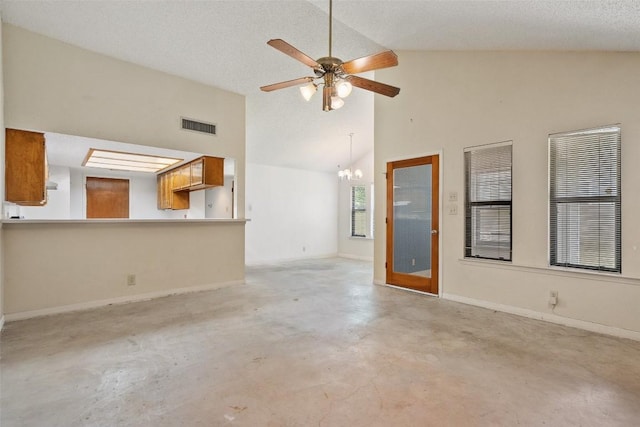 unfurnished living room with finished concrete flooring, ceiling fan, a chandelier, high vaulted ceiling, and baseboards