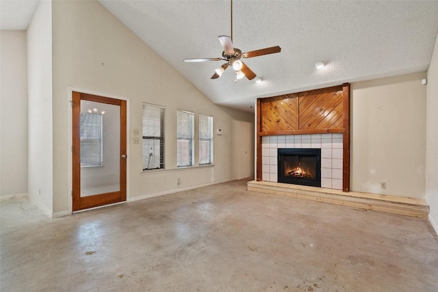 3317 William Cannon Dr Unit A, Austin, TX 78745 - unfurnished living room with concrete floors, a tiled fireplace, a ceiling fan, lofted ceiling, and baseboards