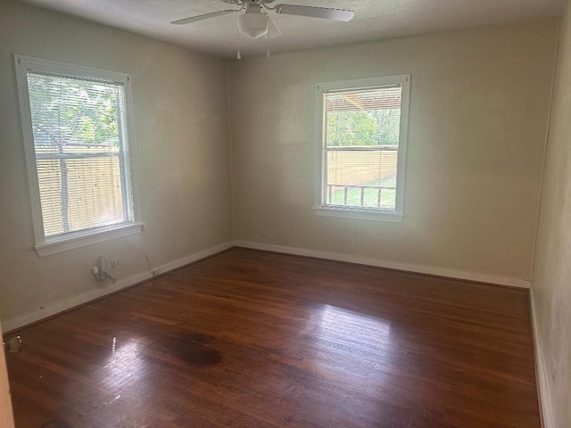 762 E Walnut St, La Grange, TX 78945 - spare room with healthy amount of natural light, wood finished floors, a ceiling fan, and baseboards