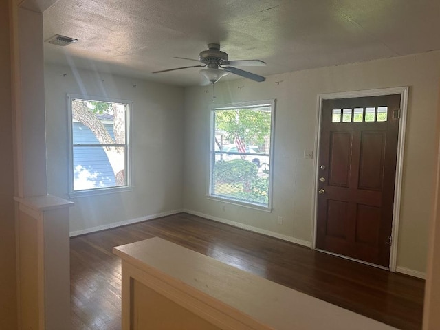 762 E Walnut St, La Grange, TX 78945 - foyer entrance with dark wood-style flooring, ceiling fan, a textured ceiling, and baseboards