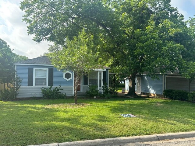 762 E Walnut St, La Grange, TX 78945 - view of property hidden behind natural elements featuring a front lawn