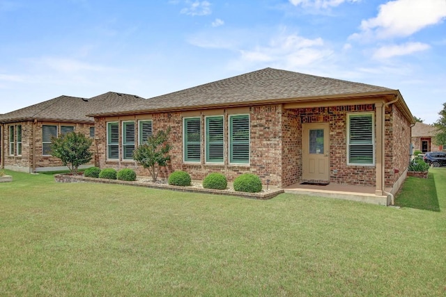 122 Coffee Mill Creek Rd, Georgetown, TX 78633 - view of front facade featuring brick siding, a shingled roof, and a front lawn