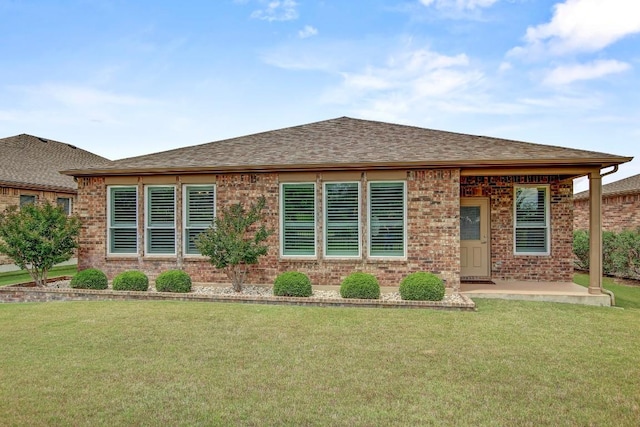 122 Coffee Mill Creek Rd, Georgetown, TX 78633 - view of front of home featuring brick siding, a front lawn, roof with shingles, and a patio area