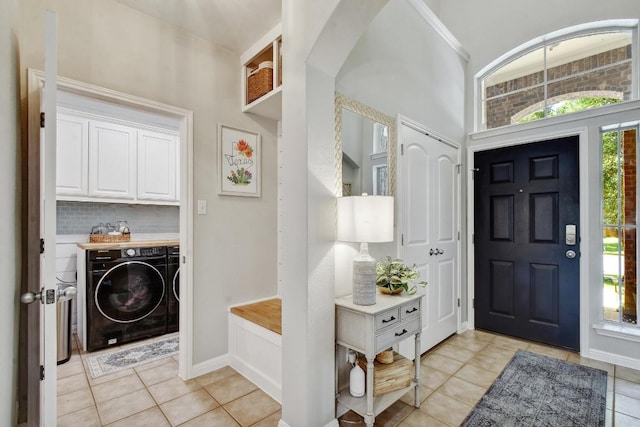 410 Easton Dr, San Marcos, TX 78666 - foyer entrance with washer and dryer, light tile patterned floors, baseboards, and arched walkways