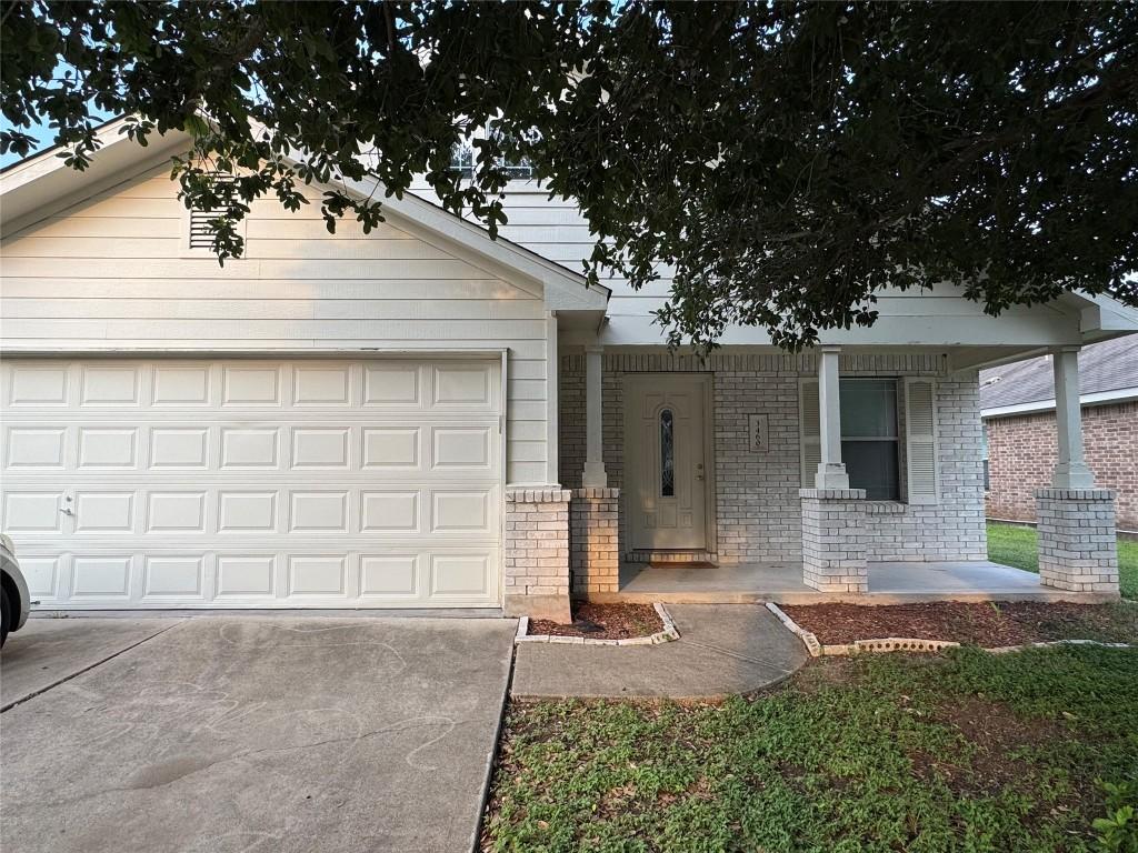 3460 Covered Wagon Trl, Round Rock, TX 78665 - ranch-style house with a porch, driveway, an attached garage, and brick siding
