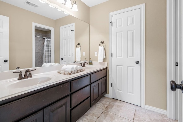285 Sand Hills Ln, Austin, TX 78737 - bathroom featuring double vanity, curtained shower, tile patterned floors, and baseboards