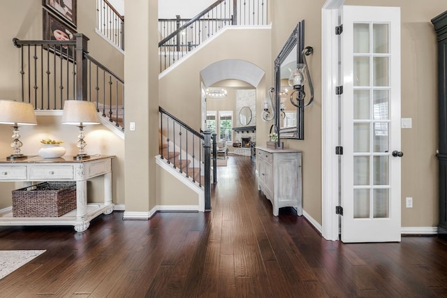 285 Sand Hills Ln, Austin, TX 78737 - foyer entrance with stairs, arched walkways, wood finished floors, a high ceiling, and baseboards