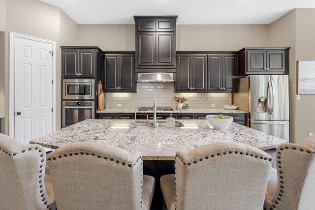 285 Sand Hills Ln, Austin, TX 78737 - kitchen with appliances with stainless steel finishes, a kitchen breakfast bar, and a sink