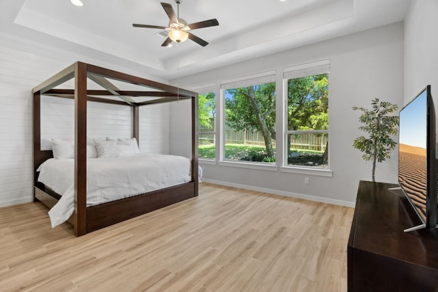 716 Dayridge Dr, Dripping Springs, TX 78620 - bedroom featuring a raised ceiling, light wood-type flooring, baseboards, a ceiling fan, and recessed lighting