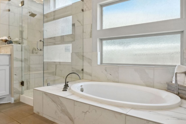 716 Dayridge Dr, Dripping Springs, TX 78620 - full bathroom with a shower stall, a bath, and tile patterned flooring