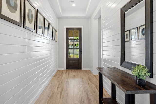 716 Dayridge Dr, Dripping Springs, TX 78620 - doorway featuring light wood-style floors, baseboards, and a raised ceiling