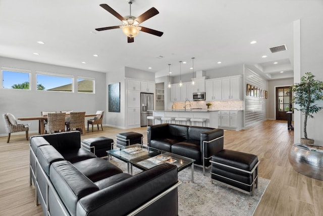 716 Dayridge Dr, Dripping Springs, TX 78620 - living room with baseboards, light wood finished floors, a ceiling fan, and recessed lighting