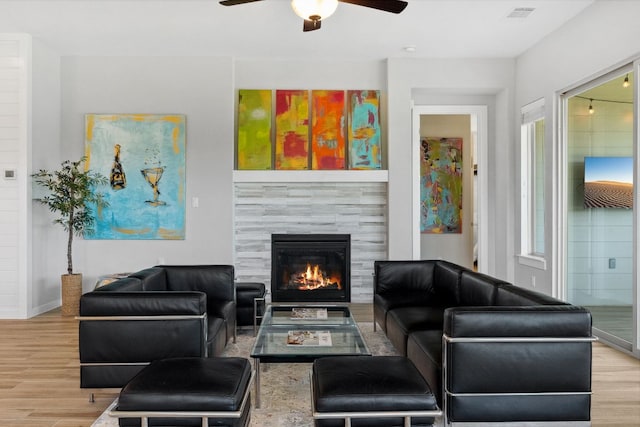 716 Dayridge Dr, Dripping Springs, TX 78620 - living area with wood finished floors, a ceiling fan, a fireplace, and baseboards