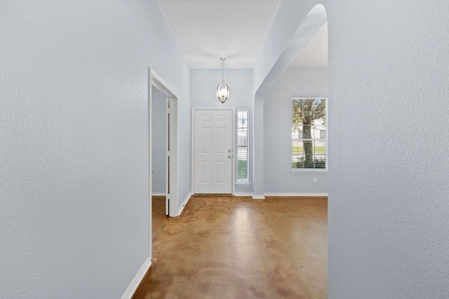 3321 Winding River Trl, Round Rock, TX 78681 - foyer featuring a textured wall, a chandelier, baseboards, and concrete flooring