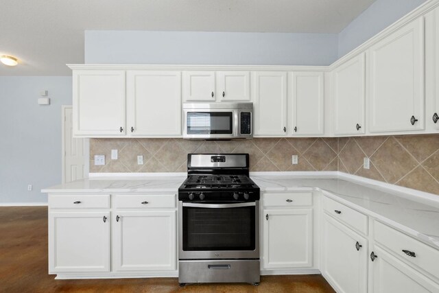 3321 Winding River Trl, Round Rock, TX 78681 - kitchen with appliances with stainless steel finishes, decorative backsplash, white cabinetry, and light stone counters
