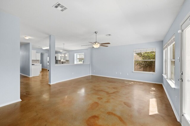3321 Winding River Trl, Round Rock, TX 78681 - unfurnished living room featuring ceiling fan, concrete flooring, plenty of natural light, and baseboards