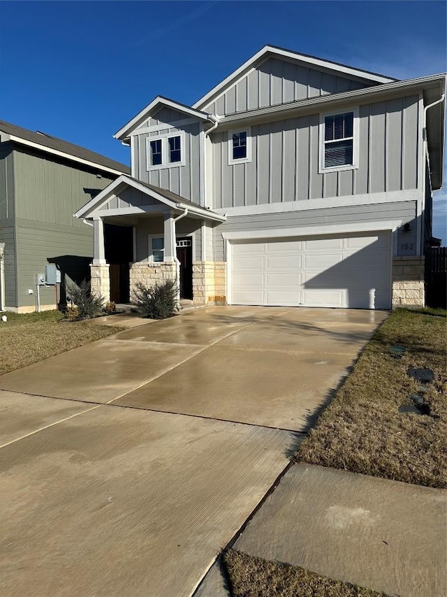 152 Mason Hill Ln, Georgetown, TX 78628 - craftsman inspired home featuring board and batten siding, a garage, stone siding, and concrete driveway