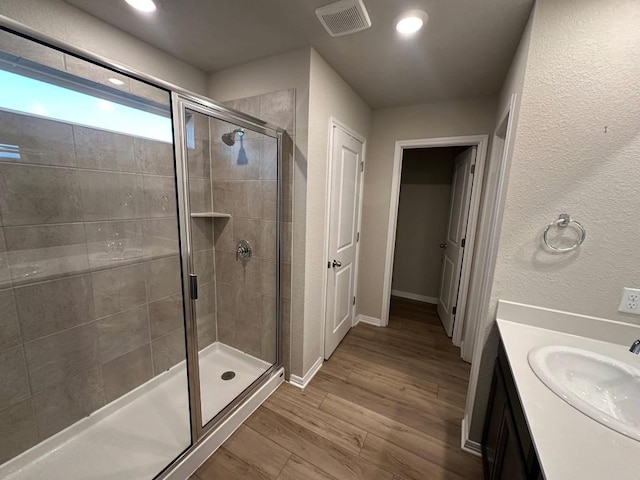 152 Mason Hill Ln, Georgetown, TX 78628 - full bath featuring a stall shower, wood finished floors, vanity, baseboards, and recessed lighting