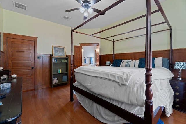 11036 Cherisse Dr, Austin, TX 78739 - bedroom with a wainscoted wall, wood finished floors, wooden walls, and ceiling fan