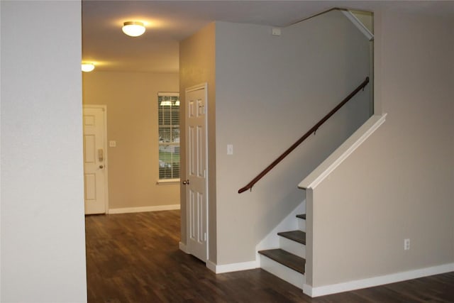 staircase with wood finished floors and baseboards