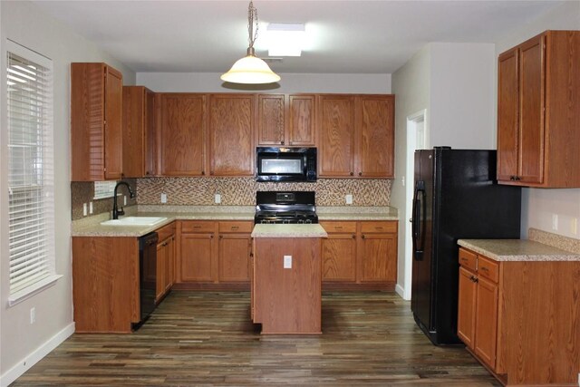 18354 Basket Flower Bnd, Elgin, TX 78621 - kitchen with black appliances, a center island, dark wood finished floors, decorative backsplash, and light countertops