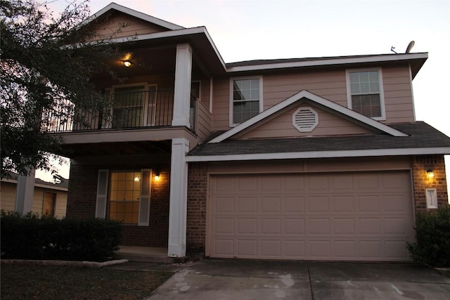18354 Basket Flower Bnd, Elgin, TX 78621 - view of front of house with brick siding, a balcony, concrete driveway, and a garage