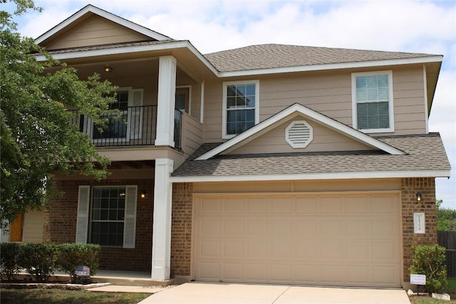 18354 Basket Flower Bnd, Elgin, TX 78621 - view of front of property featuring a balcony, driveway, roof with shingles, brick siding, and a garage