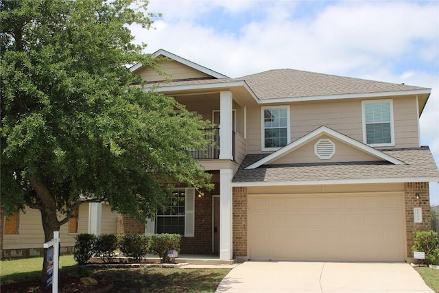 18354 Basket Flower Bnd, Elgin, TX 78621 - view of front facade featuring concrete driveway, a shingled roof, brick siding, and a balcony