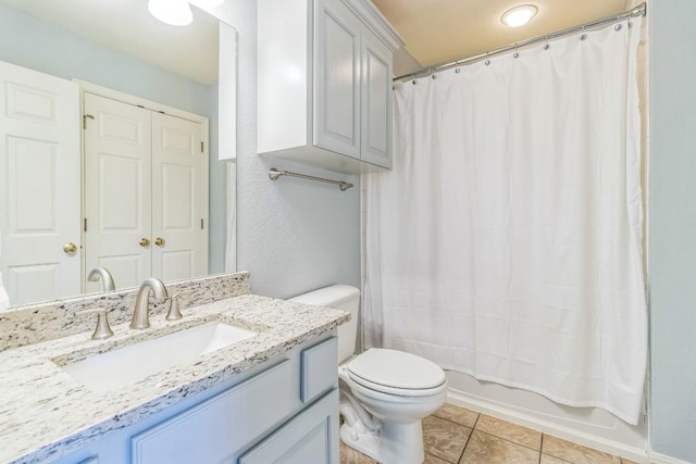 full bathroom with toilet, tile patterned floors, vanity, and shower / bath combo