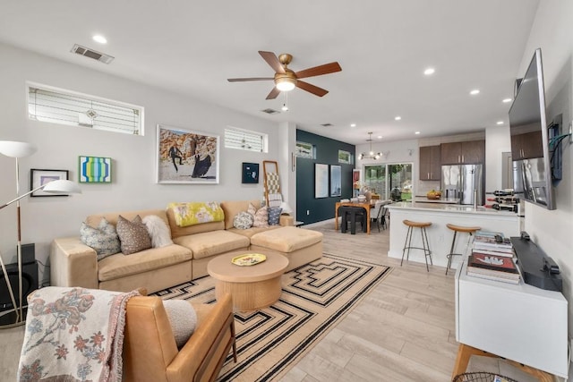 5202 Rob Scott St, Austin, TX 78721 - living area with ceiling fan, recessed lighting, a chandelier, and light wood-style flooring