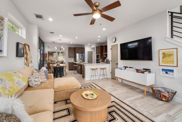 5202 Rob Scott St, Austin, TX 78721 - living room with healthy amount of natural light, a chandelier, ceiling fan, recessed lighting, and light wood-style floors
