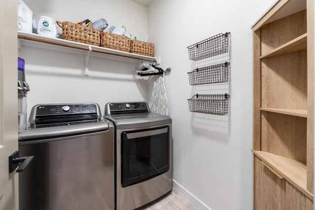 5202 Rob Scott St, Austin, TX 78721 - laundry room featuring washing machine and clothes dryer and light wood-style flooring
