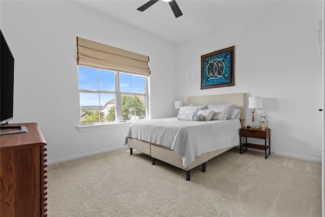 carpeted bedroom with baseboards and ceiling fan