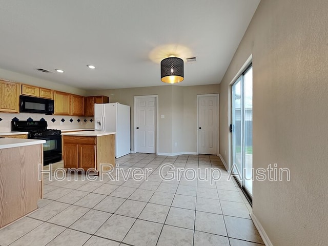 1481 Newbury St, Georgetown, TX 78626 - kitchen with black appliances, light countertops, light tile patterned floors, and decorative backsplash