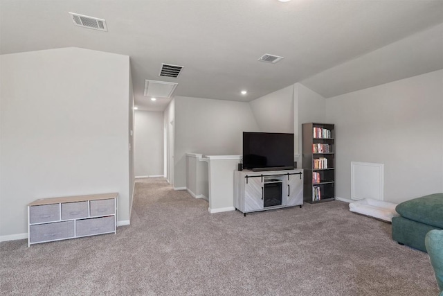 503 Windy Reed Rd, Hutto, TX 78634 - carpeted living area featuring vaulted ceiling, attic access, and baseboards