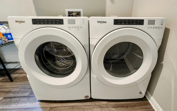 503 Windy Reed Rd, Hutto, TX 78634 - laundry area with separate washer and dryer, wood finished floors, and baseboards