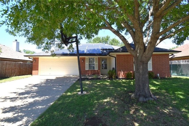 2803 Mason Dr, Killeen, TX 76549 - ranch-style home featuring a garage, brick siding, concrete driveway, and solar panels