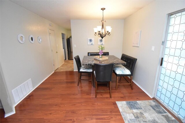 2803 Mason Dr, Killeen, TX 76549 - dining area featuring a chandelier, wood finished floors, and baseboards