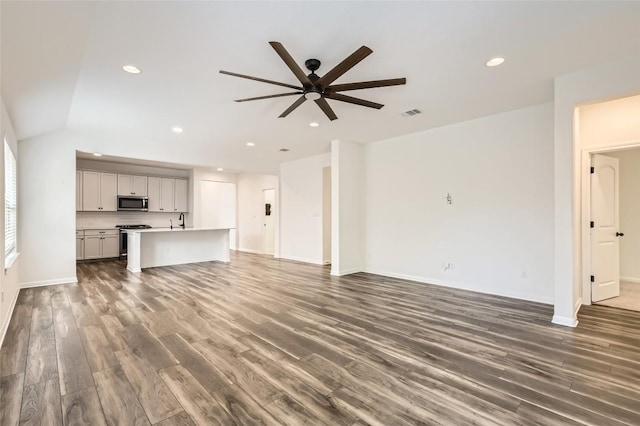 552 Windom Way, Georgetown, TX 78626 - unfurnished living room with a ceiling fan, wood finished floors, a sink, recessed lighting, and baseboards