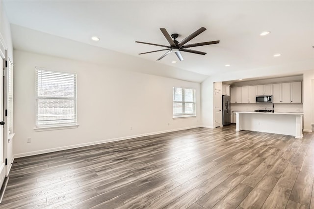 552 Windom Way, Georgetown, TX 78626 - unfurnished living room featuring ceiling fan, dark wood-style flooring, baseboards, recessed lighting, and lofted ceiling