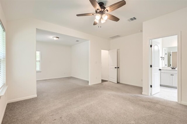 552 Windom Way, Georgetown, TX 78626 - spare room with light carpet, a ceiling fan, baseboards, and a sink