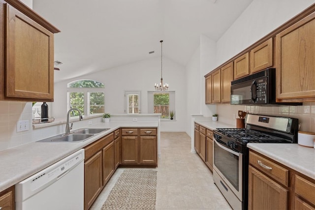 kitchen featuring gas range, dishwasher, a sink, black microwave, and a peninsula